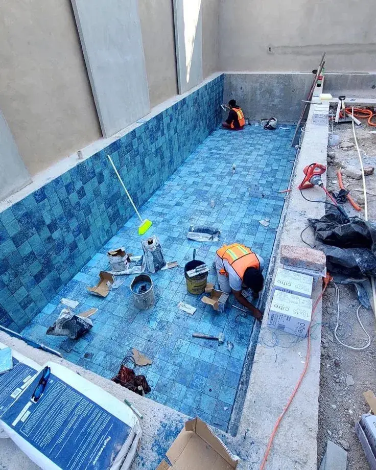 Altaif technicians working on pool tile replacement in Dubai villa